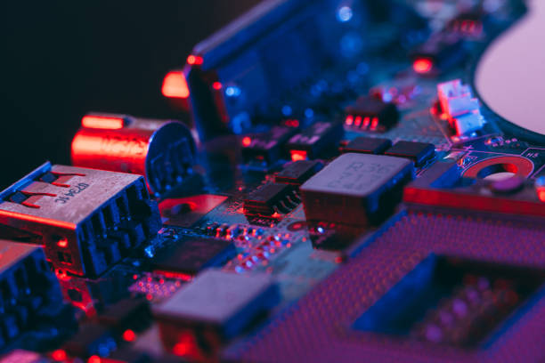 istock Hardware technology concept in neon light. Motherboard in blue-red light. 1292735538