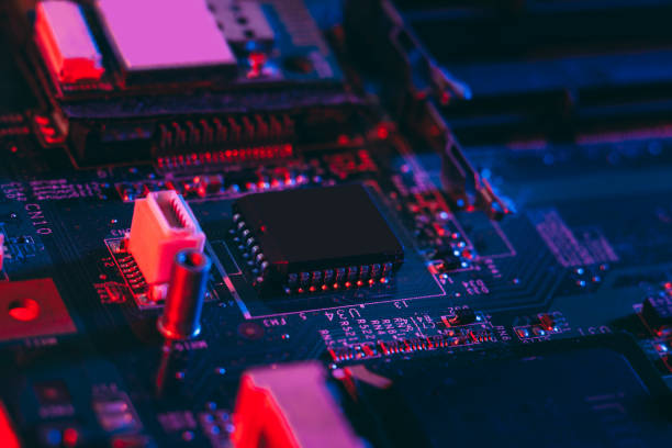 istock Hardware technology concept in neon light. Motherboard in blue-red light. 1292735616