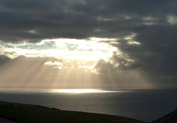 istock Sunrays in moody sky on the Jurassic Coast, Dorset, England 1292737642