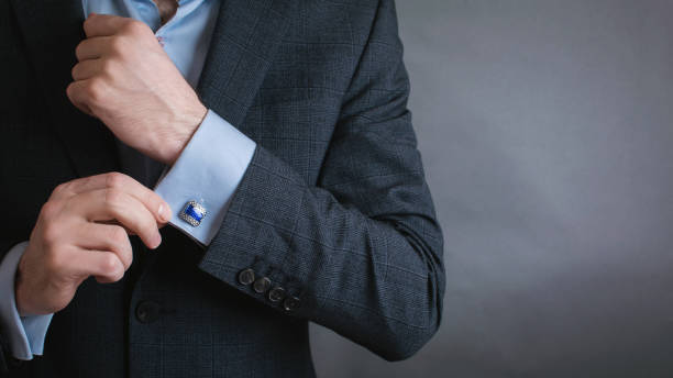 istock hand men wears cufflinks close up 1292738706