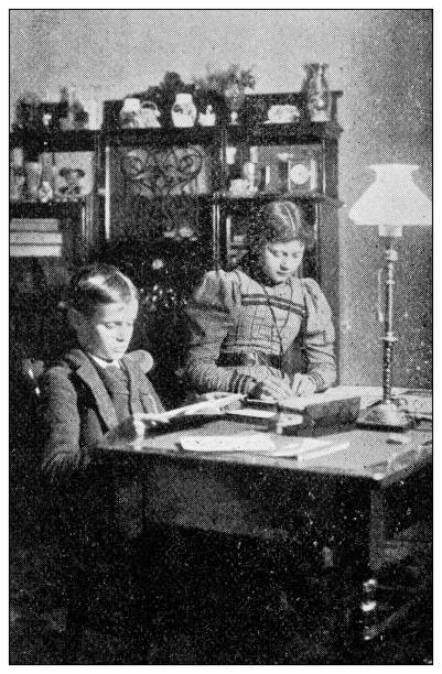 istock Antique dotprinted black and white photograph: Children writing 1292738856