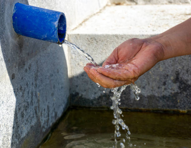 istock fills natural spring water into the palm of hand 1292738921