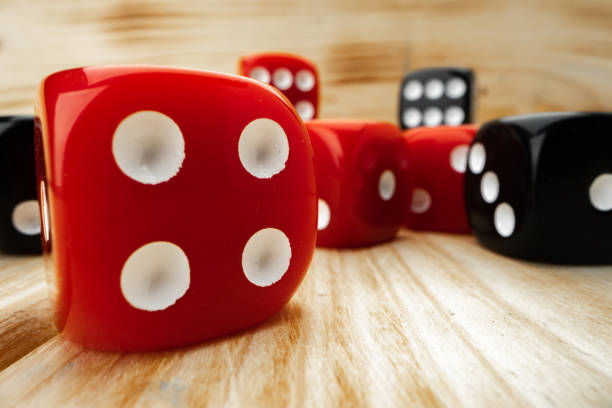 istock Red and black dice cubes on wooden background 1292738947