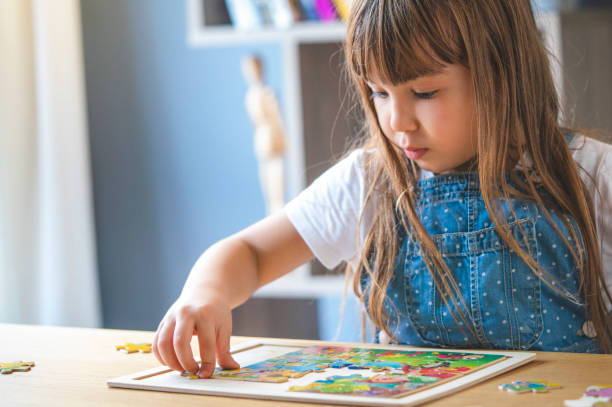 istock Little girl playing with puzzles at home 1292739896