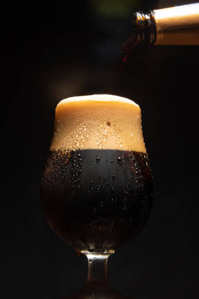 istock Beer, glass of cold beer with dark background, selective focus. 1292739992