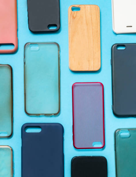 istock Pile of multicolored plastic back covers for mobile phone. Choice of smart phone protector accessories on blue background. A lot of silicone phone backs or skins next to each other 1292740187