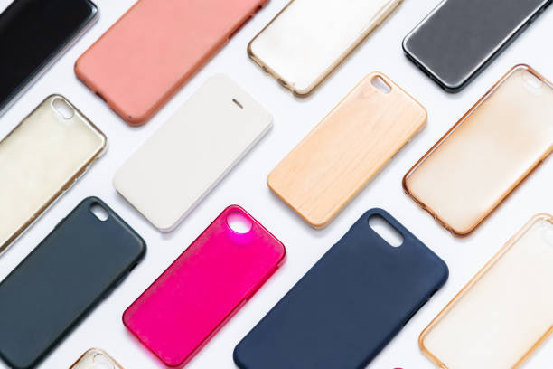 istock Pile of multicolored plastic back covers for mobile phone. Choice of smart phone protector accessories on white background. A lot of silicone phone backs or skins next to each other 1292740239