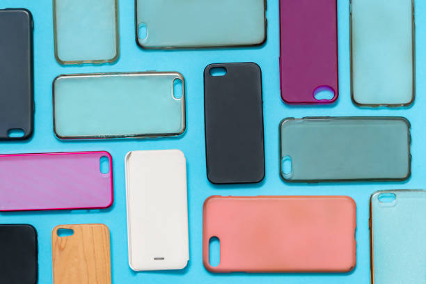 istock Pile of multicolored plastic back covers for mobile phone. Choice of smart phone protector accessories on blue background. A lot of silicone phone backs or skins next to each other 1292740241