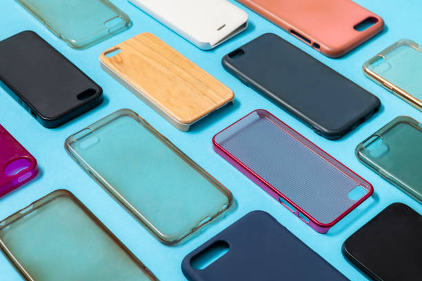 istock Pile of multicolored plastic back covers for mobile phone. Choice of smart phone protector accessories on blue background. A lot of silicone phone backs or skins next to each other 1292740393