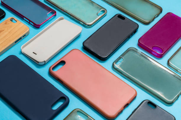 istock Pile of multicolored plastic back covers for mobile phone. Choice of smart phone protector accessories on blue background. A lot of silicone phone backs or skins next to each other 1292740420