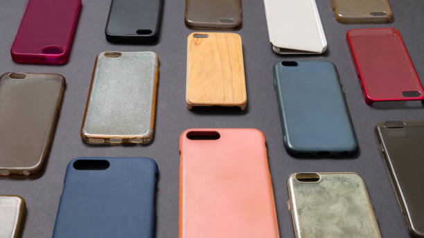 istock Pile of multicolored plastic back covers for mobile phone. Choice of smart phone protector accessories on black background. A lot of silicone phone backs or skins next to each other 1292740517