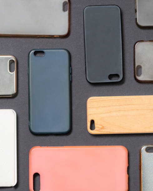 istock Pile of multicolored plastic back covers for mobile phone. Choice of smart phone protector accessories on black background. A lot of silicone phone backs or skins next to each other 1292740526