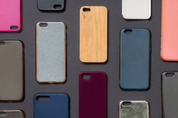 istock Pile of multicolored plastic back covers for mobile phone. Choice of smart phone protector accessories on black background. A lot of silicone phone backs or skins next to each other 1292740528