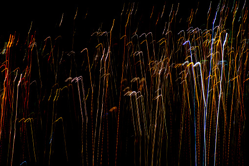 Abstract motion-blurred street lights at night captured with long exposure time.