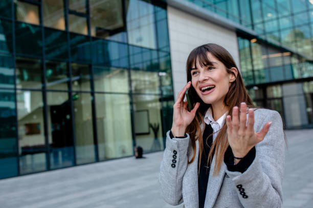 istock Business women using mobile outdoors 1292741565