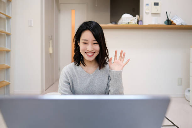 istock Young woman having virtual happy hour at home 1292742547