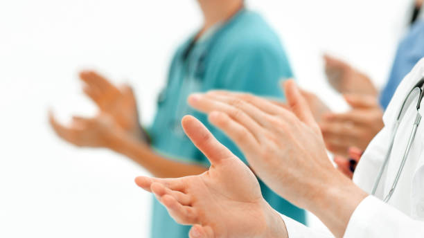 background image.groups of doctors applauding at the meeting stock photo