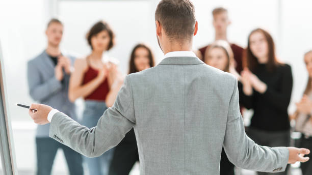 istock rear view. speaker standing standing in front of the seminar audience 1292743440