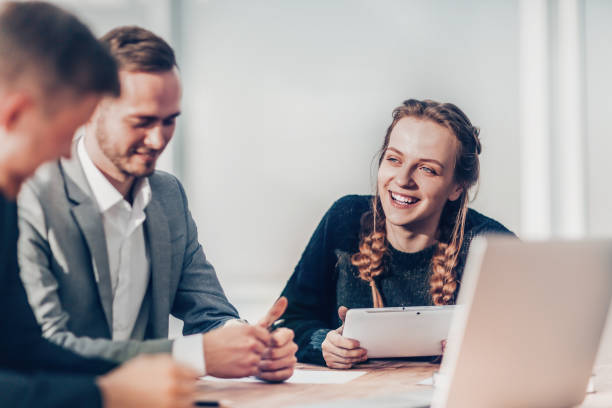 istock smiling young woman at a meeting with a working group 1292743613