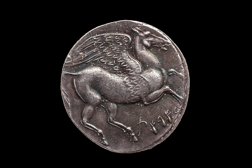 Silver 5 shekel Carthaginian coin replica with portrait of Tanit the sky goddess and the winged horse Pegasus on the reverse from the First Punic War 264-260 BC cut out isolated on a black background
