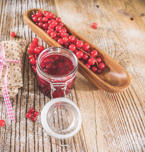 istock Currant  with toast and jam over wooden table 1292745775
