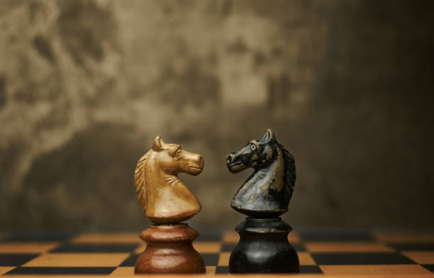 istock Knights chess pieces facing each other. 1292747118