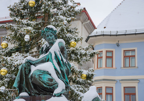 Graz, Austria-December 03, 2020: Erzherzog Johann fountain (1893, unknown author) at main square Hauptplatz, in winter, in Graz, Styria region, Austria.