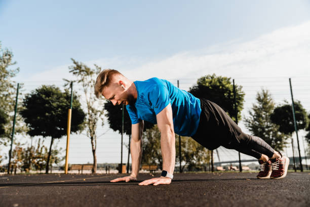 istock Side view photo of strong fit athlete doing plank on sporting ground 1292749801