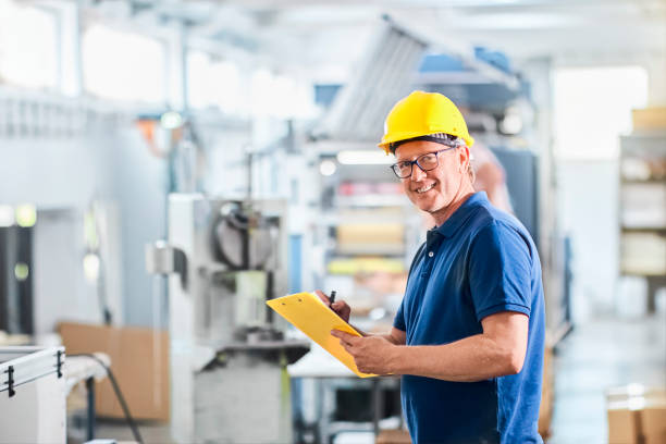 istock Successful foreman manager or engineer working with data and controlling work of industrial machine 1292751172