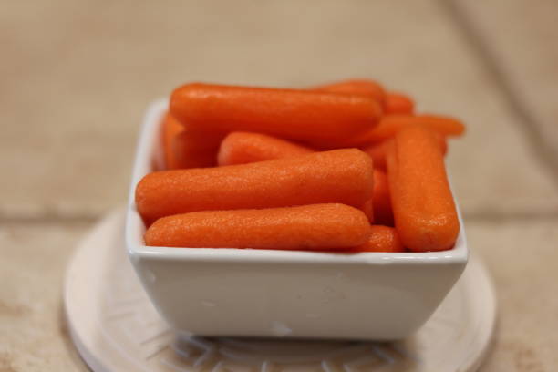 istock Cut and peeled baby carrots 1292751403