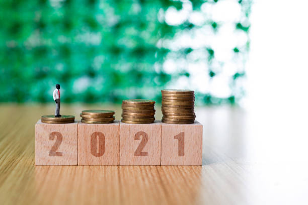 istock Coins on toy block and figurine 1292752058