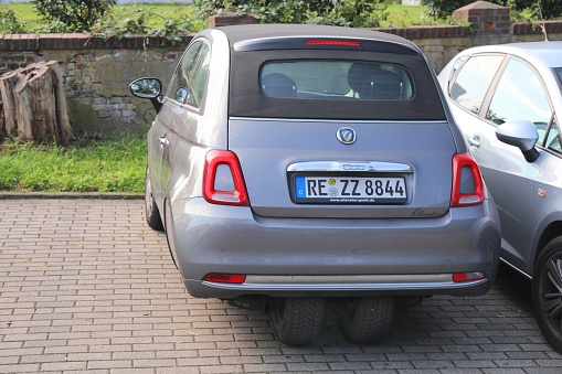 Fiat 500 Ellenator bizarre modified car parked in Germany. Two wheels on a narrow axle exploit a legal loophole allowing 16 year olds to drive cars on A1 license.