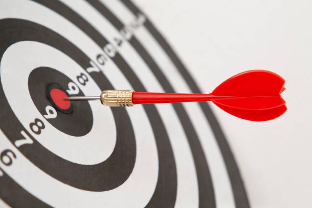 istock Red dart arrow target on center of dartboard. 1292753725