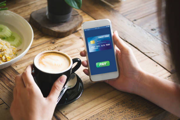 istock cafe making show shopping transfer payment through smartphone app Mobile Payment with NFC technology on Smartphone shopping online 1292754282