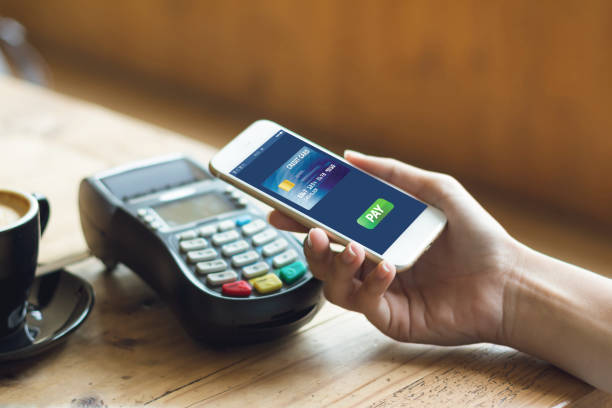 istock cafe making show shopping transfer payment through smartphone app Mobile Payment with NFC technology on Smartphone shopping online 1292754307