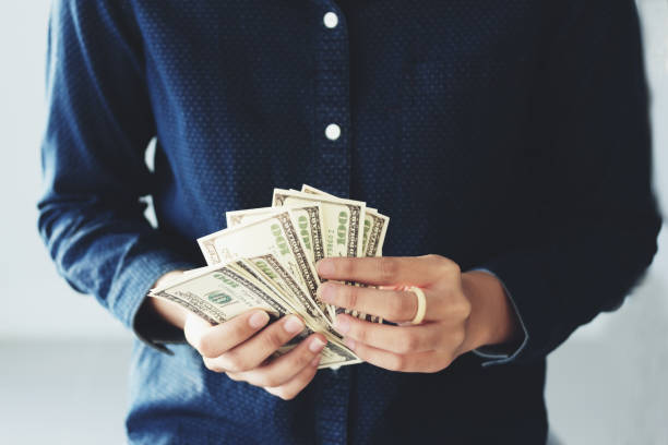 istock Hands holding us dollar  saving money concept financial 1292754991