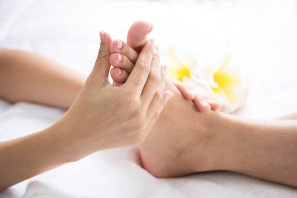 istock Foot massage in spa salon, closeup 1292755043