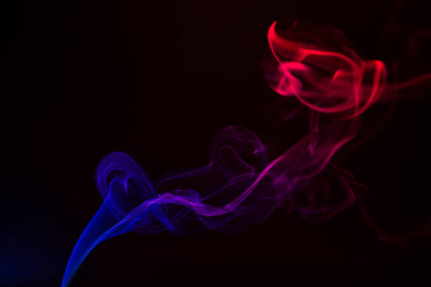 istock Colorful smoke close-up on a black background 1292755560