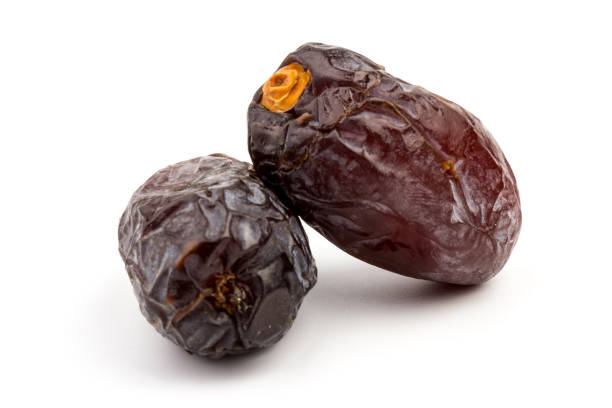 istock Dried dates fruits isolated on white background 1292756894