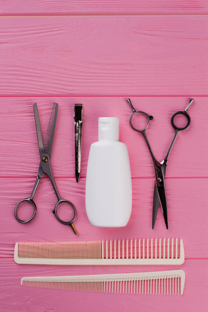 istock Professional hairdresser tools on pink background. 1292757344