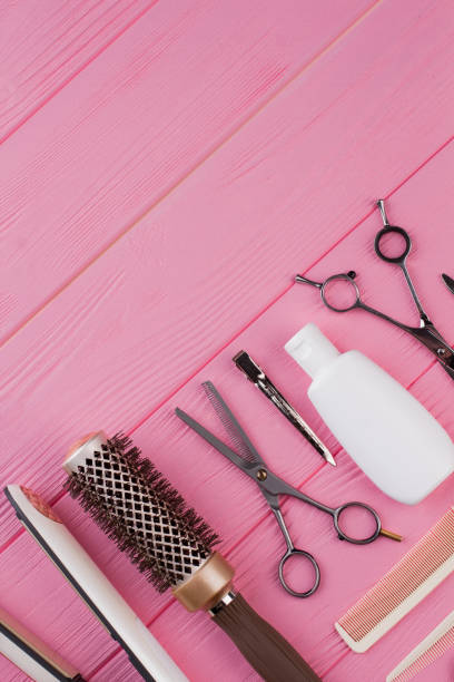 istock Hairdressing tools on pink background. 1292757490
