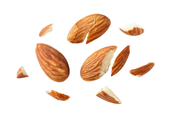 istock almonds baked pieces snack  and cracks Spread out  on white isolated .Clipping path - 1292757568