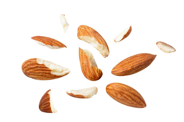 istock almonds baked pieces snack  and cracks Spread out  on white isolated .Clipping path - 1292757571