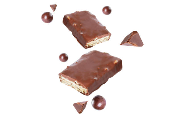 istock broken chocolate cacao milk piece bar on air  white isolated 1292758287