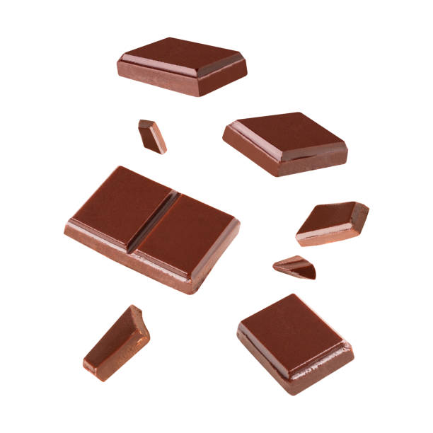 istock Three dark chocolate pieces Blast pieces in the air on a white background .Clipping path 1292758972