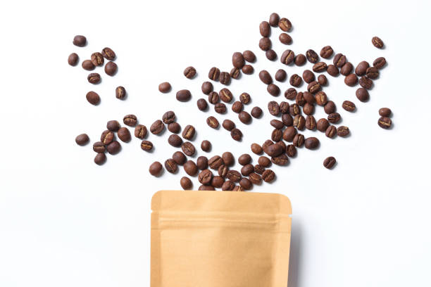 istock roasted coffee bean splash seed  texture and pouch topview on white isolated 1292759537