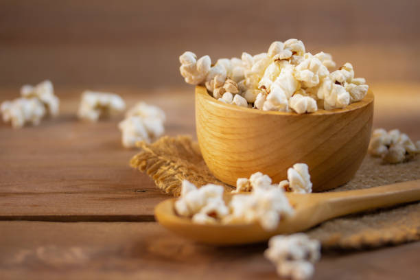 popcorn in a wooden cup and on a wooden board