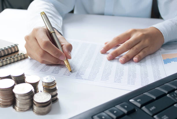 istock businessman hand working with finances about cost and calculator  on withe desk in modern office 1292760909