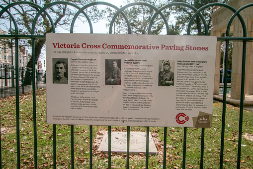 Victoria Cross Commemorative Paving Stones at Brighton War Memorial in East Sussex, England, which features the pictures and names of three of the heroes of World War I who came from Brighton & Hove. The Brighton & Hove city council logo is in the bottom corner