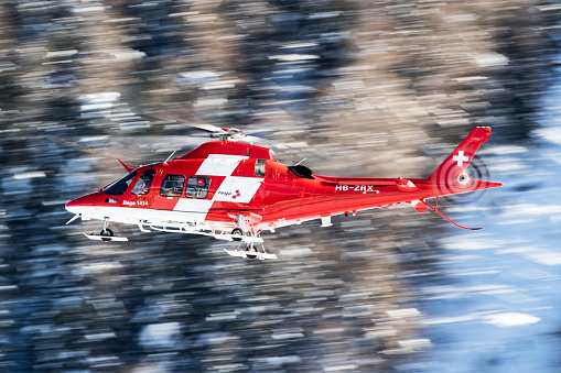 St. Moritz, Switzerland - December 18, 2020: Rega is a private, non-profit air rescue service that provides emergency medical assistance in Switzerland and Liechtenstein. Rega mainly assists with mountain rescues, though it will also operate in other terrains when needed, most notably during life-threatening emergencies.